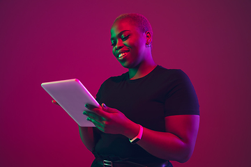 Image showing African-american young woman\'s portrait on purple pink background