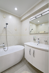 Image showing Compact white cozy bathroom with bathub