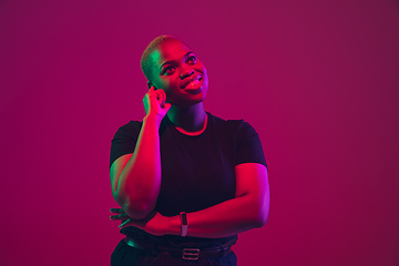 Image showing African-american young woman\'s portrait on purple pink background