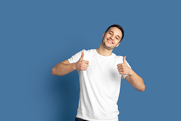 Image showing Caucasian young man\'s portrait on blue studio background