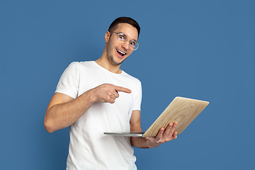 Image showing Caucasian young man\'s portrait on blue studio background