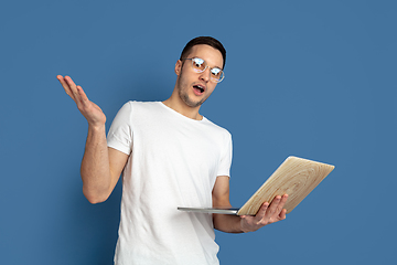 Image showing Caucasian young man\'s portrait on blue studio background