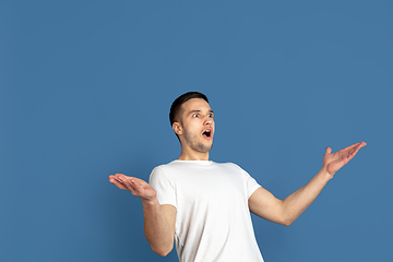 Image showing Caucasian young man\'s portrait on blue studio background