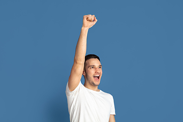 Image showing Caucasian young man\'s portrait on blue studio background