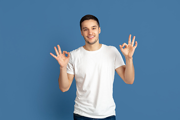 Image showing Caucasian young man\'s portrait on blue studio background