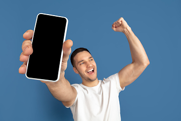 Image showing Caucasian young man\'s portrait on blue studio background