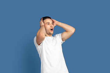 Image showing Caucasian young man\'s portrait on blue studio background