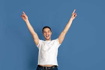 Image showing Caucasian young man\'s portrait on blue studio background