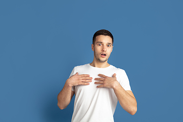 Image showing Caucasian young man\'s portrait on blue studio background