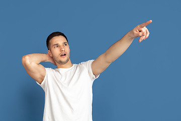 Image showing Caucasian young man\'s portrait on blue studio background