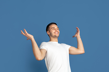 Image showing Caucasian young man\'s portrait on blue studio background