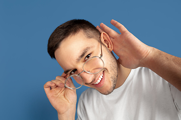 Image showing Caucasian young man\'s portrait on blue studio background