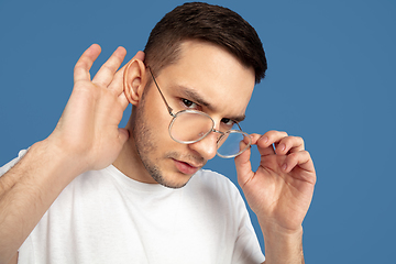 Image showing Caucasian young man\'s portrait on blue studio background