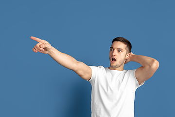 Image showing Caucasian young man\'s portrait on blue studio background