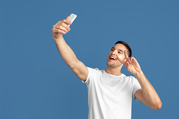 Image showing Caucasian young man\'s portrait on blue studio background