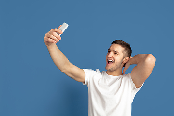 Image showing Caucasian young man\'s portrait on blue studio background