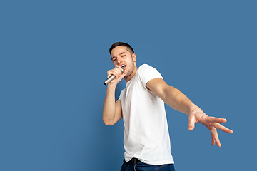 Image showing Caucasian young man\'s portrait on blue studio background