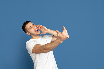 Image showing Caucasian young man\'s portrait on blue studio background