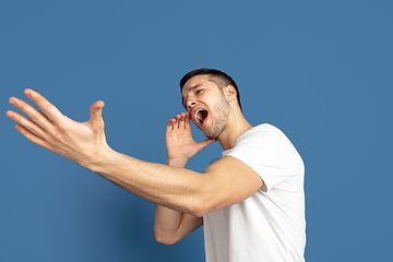 Image showing Caucasian young man\'s portrait on blue studio background