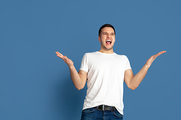 Image showing Caucasian young man\'s portrait on blue studio background