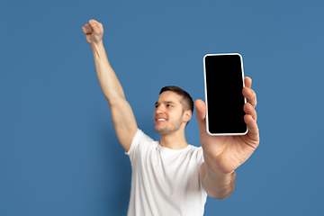 Image showing Caucasian young man\'s portrait on blue studio background