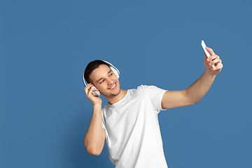 Image showing Caucasian young man\'s portrait on blue studio background