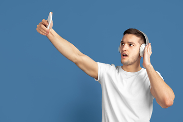 Image showing Caucasian young man\'s portrait on blue studio background