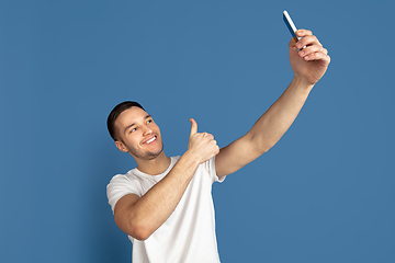 Image showing Caucasian young man\'s portrait on blue studio background