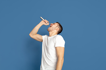 Image showing Caucasian young man\'s portrait on blue studio background