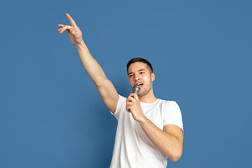 Image showing Caucasian young man\'s portrait on blue studio background