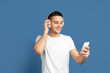 Image showing Caucasian young man\'s portrait on blue studio background