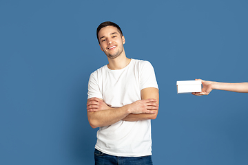 Image showing Caucasian young man\'s portrait on blue studio background