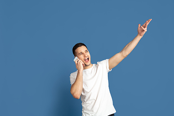 Image showing Caucasian young man\'s portrait on blue studio background