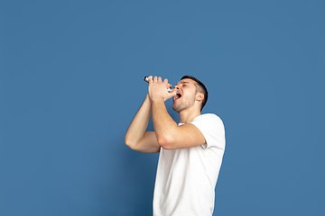 Image showing Caucasian young man\'s portrait on blue studio background