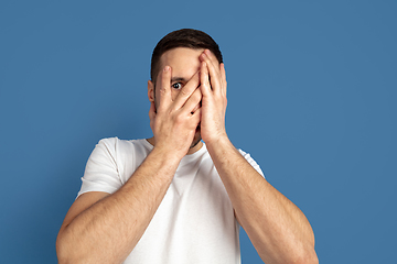 Image showing Caucasian young man\'s portrait on blue studio background