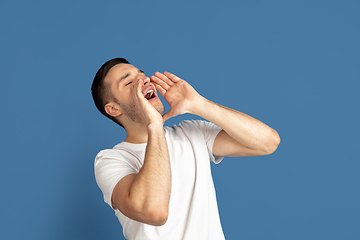 Image showing Caucasian young man\'s portrait on blue studio background