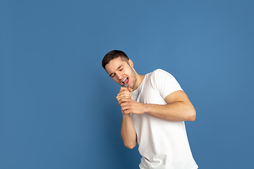 Image showing Caucasian young man\'s portrait on blue studio background