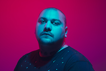 Image showing Portrait of a guy with colorful neon light on red background - cyberpunk concept