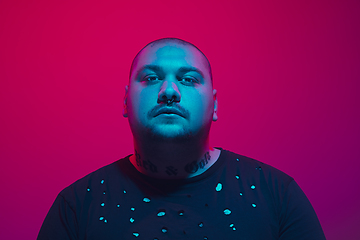 Image showing Portrait of a guy with colorful neon light on red background - cyberpunk concept