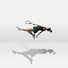 Image showing Young caucasian professional sportswoman levitating, flying while playing tennis isolated on white background