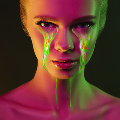 Image showing Portrait of young beautiful woman with neon, fluid tears from eyes. Concept of fashion and beauty, emotions and feelings, modern design