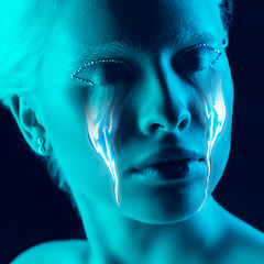 Image showing Portrait of young beautiful woman with neon, fluid tears from eyes. Concept of fashion and beauty, emotions and feelings, modern design