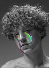 Image showing Portrait of young beautiful man with neon, fluid tears from eyes. Concept of fashion and beauty, emotions and feelings, modern design