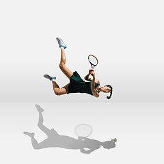 Image showing Young caucasian professional sportswoman levitating, flying while playing tennis isolated on white background