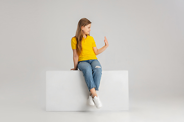 Image showing Happy kid, girl isolated on white studio background. Looks happy, cheerful, sincere. Copyspace. Childhood, education, emotions concept