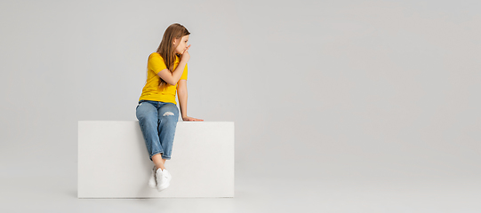 Image showing Happy kid, girl isolated on white studio background. Looks happy, cheerful, sincere. Copyspace. Childhood, education, emotions concept