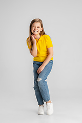 Image showing Happy kid, girl isolated on white studio background. Looks happy, cheerful, sincere. Copyspace. Childhood, education, emotions concept