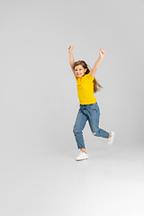 Image showing Happy kid, girl isolated on white studio background. Looks happy, cheerful, sincere. Copyspace. Childhood, education, emotions concept