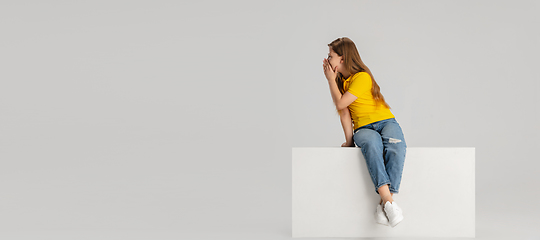 Image showing Happy kid, girl isolated on white studio background. Looks happy, cheerful, sincere. Copyspace. Childhood, education, emotions concept