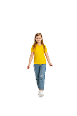 Image showing Happy kid, girl isolated on white studio background. Looks happy, cheerful, sincere. Copyspace. Childhood, education, emotions concept